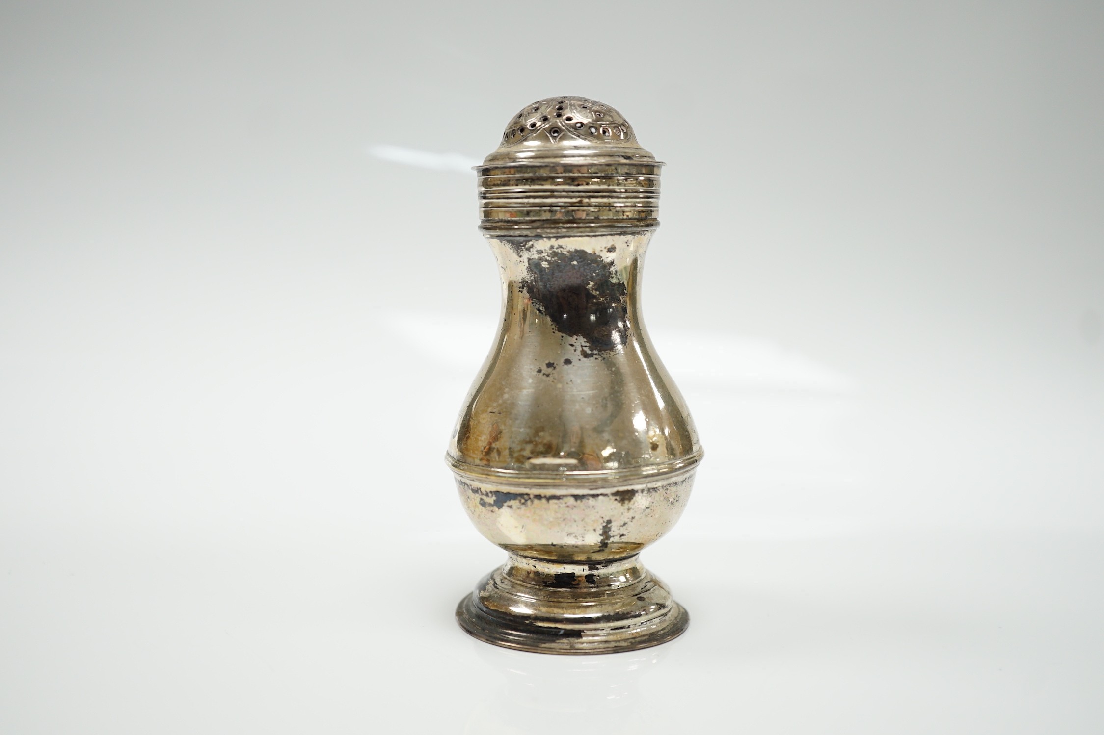 An early George II silver pepperette, maker's mark rubbed, London, 1729, 10cm.